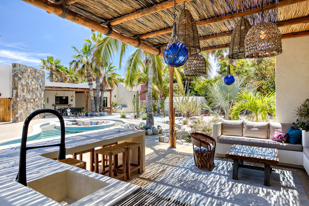 Outdoor kitchen with gas grill and pool view